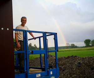 Buddy standing under a rainbow during the Shelburne build.