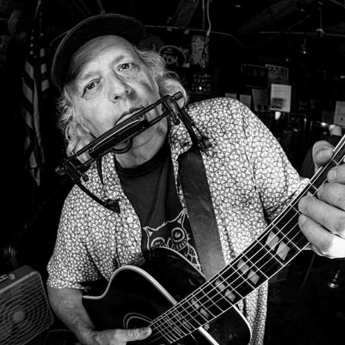 David Roberts black and white with harmonica and guitar