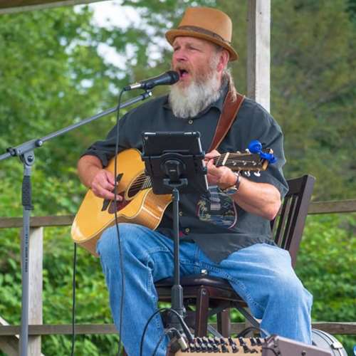George Murtie playing the guitar and Singing