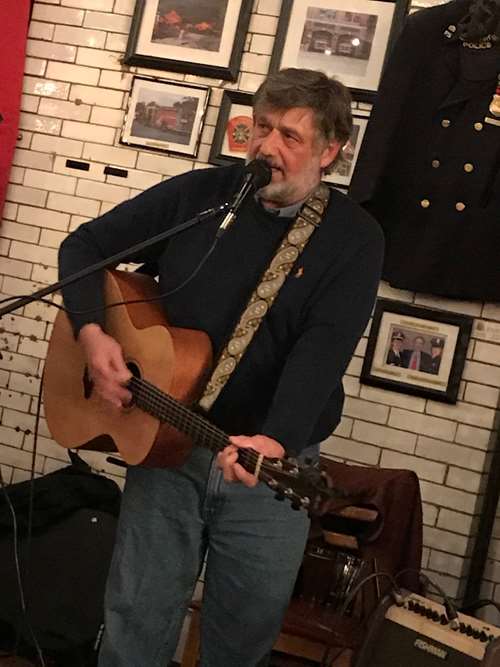 Tom bisson playing the guitar
